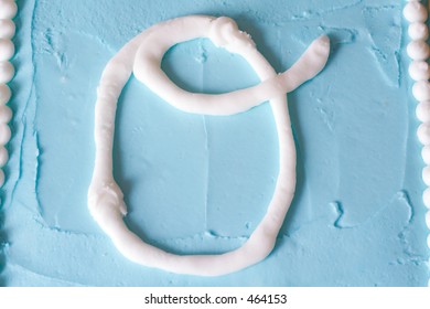 White Icing Letter O On A Blue Cake (series Spells LOVE)