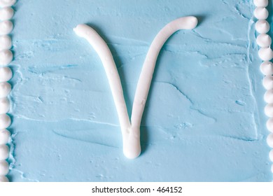 White Icing Letter V On A Blue Cake (series Spells LOVE)