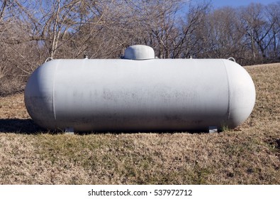 White Industrial Propane Tank In Field. Horizontal.