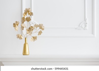 white interior. white fireplace in a light interior and a gold vase. Classical interior