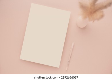 White Invitation Card Mockup With A Dried Grass And Ceramic Vase On Beige Background, Minimal Beige Workplace Composition, Flat Lay, Mockup