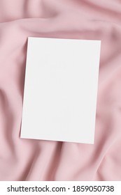 White Invitation Card Mockup On A Soft Pink Textile. 5x7 Ratio, Similar To A6, A5.