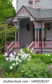 White Iris In Front Of A Stairs To A Classic Queen Anne Home