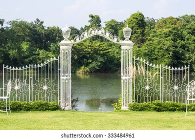 White Iron Gate And Fence In The Garden.