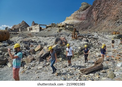 White Island, New Zealand - Circa 2016: White Island Volcanic Landscape, Tourist Group Walking In Gas Masks To See The Crater On An Organized Volcano Tour