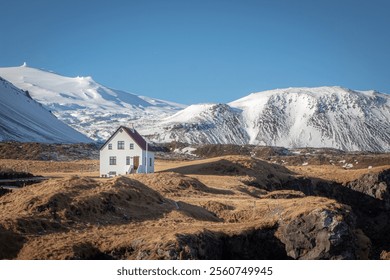 White islolated house in the mountains of the Snæfellsnes peninsula in Iceland. Photo taken on a day in January - Powered by Shutterstock