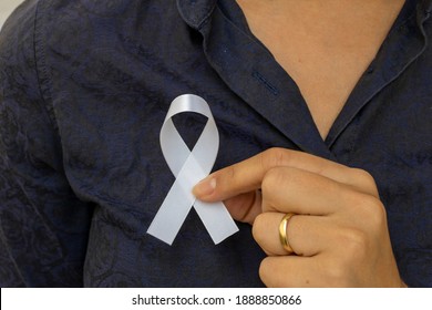 White January, Mental Health Awareness Campaign. Woman Putting White Ribbon On Her Shirt. 