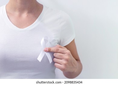 White January, Mental Health Awareness Campaign. Woman Holding A White Ribbon.