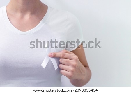 White January, mental health awareness campaign. Woman holding a white ribbon.