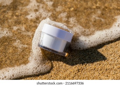 White Jar Of Cosmetic Producton The Sea Sand. Beauty Concept For Face Body Care. Travel Vacation And Sun Protection Accessory. Skin Care In Summer Day On The Beach. Face Moisturizing Cream