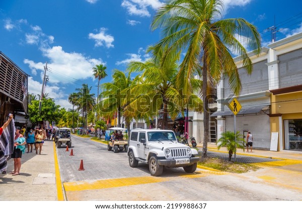 White Jeep Wrangler on the\
street on Isla Mujeres island in Caribbean Sea, Cancun, Yucatan,\
Mexico.