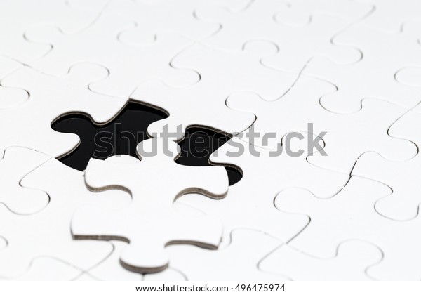 white jigsaw puzzle\
with black background