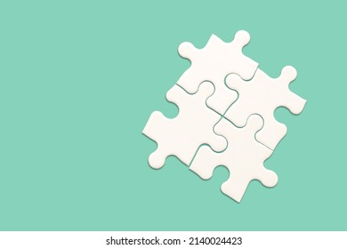 White Jigsaw Puzzle On Green Background, Find The Right Joined Team And Fit Correctly Concept