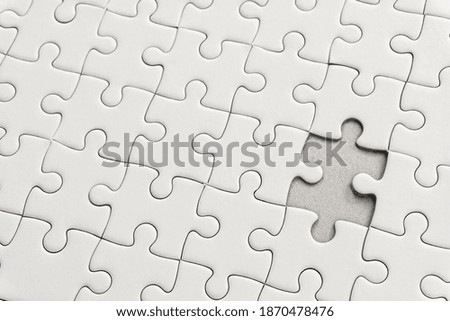 White jigsaw puzzle pattern background. placing last piece of jigsaw puzzle