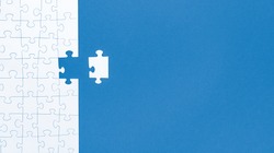 White Jigsaw Puzzle Pieces On Blue Background Copy Space For Your Text. Business Concept. 