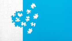 White Jigsaw Puzzle Pieces On Blue Background Copy Space For Your Text. Business Concept. 
