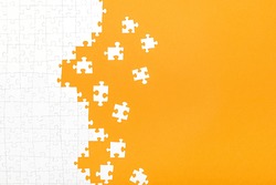 White Jigsaw Puzzle Pieces On Orange Background Copy Space For Your Text. Business Concept. 