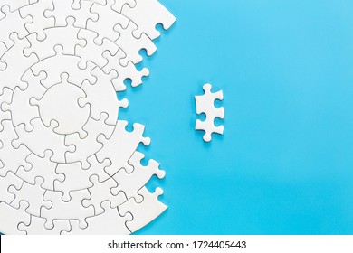 White jigsaw puzzle pieces on a blue background. Problem solving concepts. Texture photo with copy space for text - Shutterstock ID 1724405443