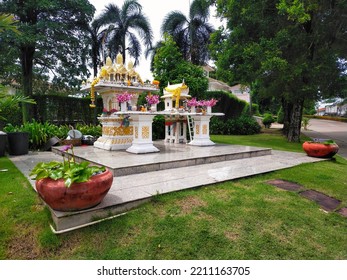 A White Joss House In Green Lawn