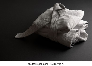 White judogi folded and tied with a white belt