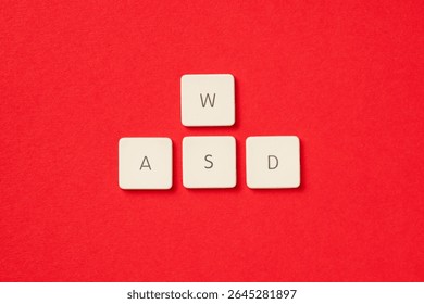 White keyboard keys arranged in WASD gaming control layout on a red backdrop. Symbolic for PC gaming, control, and e-sports.