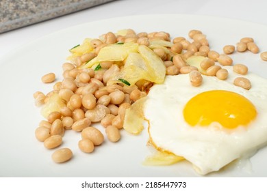 White Kidney Beans With Egg And Potato. Cooked Cannellini Bean Pile, Baked Legume, Yellow Beans Breakfast On White Plate