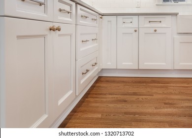 White Kitchen Built With Shaker Style Cabinets. Shows Cabinet Details And Brushed Gold Hardware Knobs And Pulls