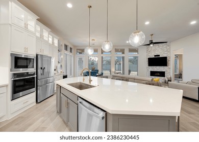  a white kitchen with a granite island 