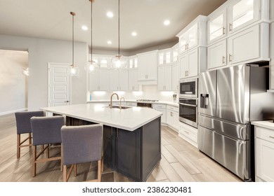  a white kitchen with a granite island  - Shutterstock ID 2386230481
