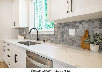 White Kitchen With Stools Tile Backsplash Chefs Island Stainless Appliances Wood Floor