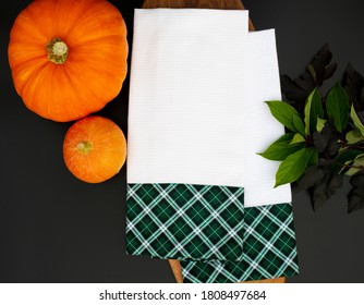 White Kitchen Towel Mockup With Green Decor, Leaves And Pumkin