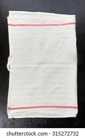 White Kitchen Towel On A Dark Background. Space For Writing Text