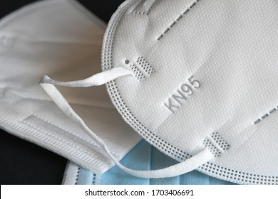 white KN95 or N95 mask with antiviral medical mask for protection against coronavirus on black background. Surgical protective mask. prevention of the spread of virus and pandemic COVID-19.