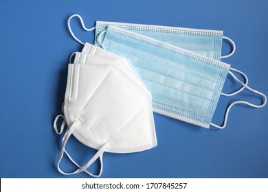 white KN95 or N95 mask with antiviral medical mask for protection against coronavirus on blue background. Surgical protective mask. prevention of the spread of virus and pandemic COVID-19.