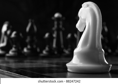 White Knight Chess Piece On The Board Background