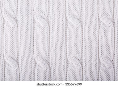 White knitted background. Knitwear fabric texture.