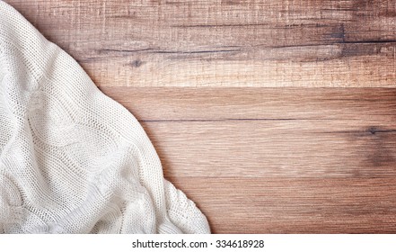 White Knitted Blanket On Wooden Background