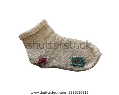      White knitted wool sock darned with colored threads. The item is isolated on a white background.     