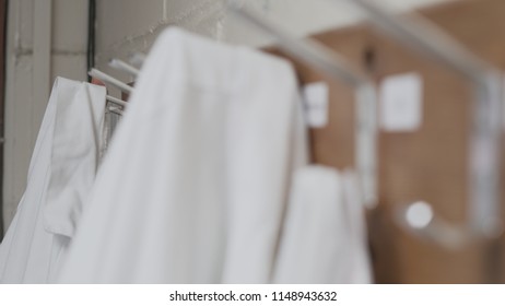 White Lab Coats Hanging On Coat Rack