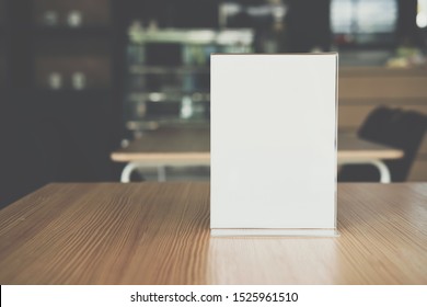 White Label In Cafe. Display Stand For Acrylic Tent Card In Coffee Shop. Mockup Menu Frame On Table In Bar Restaurant. Space For Text