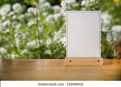 White Label On The Table. Stand For Acrylic Tent Card Used For Menu Bar And Restaurant Or Put Everything Into It . Mockup 