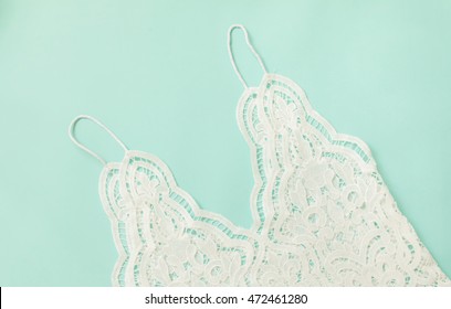 White Lace Spaghetti Strap On Soft Blue Background.