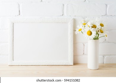 White Landscape Frame Mockup With Daisy Flower In Styled Vase Near Painted Brick Wall. Empty Frame Mock Up For Presentation Design.  Template Framing For Modern Art.