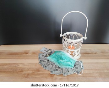 White lantern with an orange candle, 100 dollar banknotes and a mask on the table with black backdrop. Concept - Ramadan kareem holiday celebration in time of quarantine. Royalty Free Stock photo