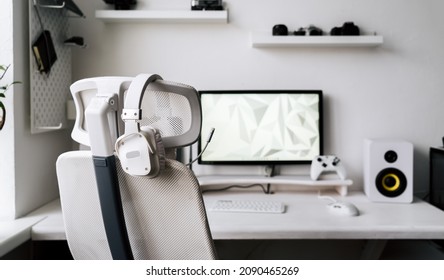 White Large Gaming Headphones With A Microphone Hang On A White Armchair. Close-up