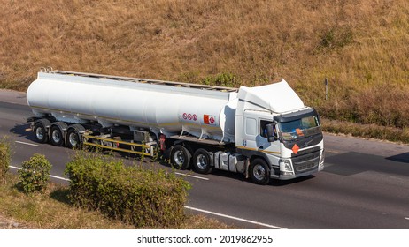 White Large Tanker Fuel Liquid Truck Industrial Vehicle Driver Driving Road Highway Overhead Photo.