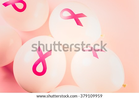 White latex balloos with pink reibbons.