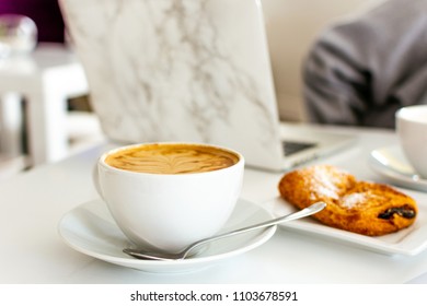 White Latte In Mug With Croissant At Coffee Shop Cafe Laptop Marble Woman Girl In Blurred Background Negative Space Copy Art Spoon Freelance Work Remotely