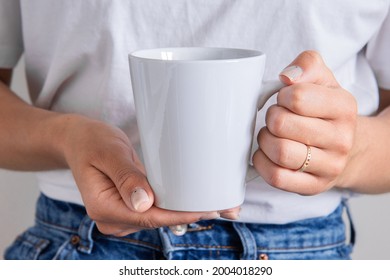 White Latte Mug In The Hands Of The Girl For Presentation Custom Sublimation Print. Blank Mug Photo Mockup Template