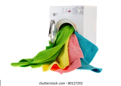 White laundromat with colorful landry in open door